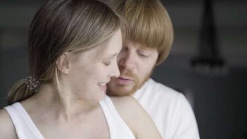 Front view of cheerful couple talking and touching belly Stock Footage 121913254