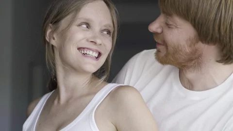 Front view of cheerful couple talking and rubbing belly Stock Footage 121913309