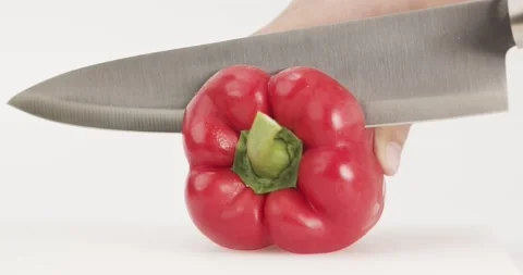 Front view, Chef uses a knife to cut red bell peppers. Stock Footage 167247766
