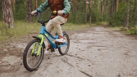 Front view of child cycling on forest road Video stock 315756736