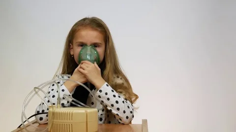 Front view of the child holding a mask from a nebulizer Video stock 83762368