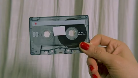 Front view of a classic audio cassette held by hands. Stock Footage 327687606