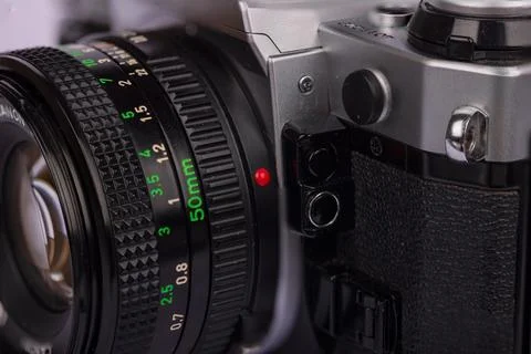 Front view of a classic camera with its lens locking mechanism visible, on .. Stock Photos