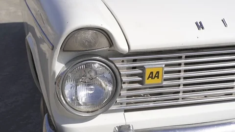 Front view of a classic open top Hillman Super Minx cabriolet on the beach Stock Footage 116725857