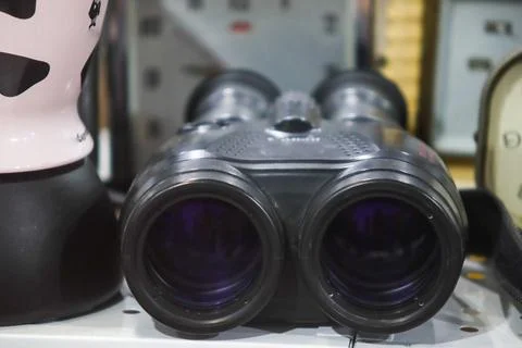 Front view close up of black vintage binoculars optical equipment on displa.. Stock Photos
