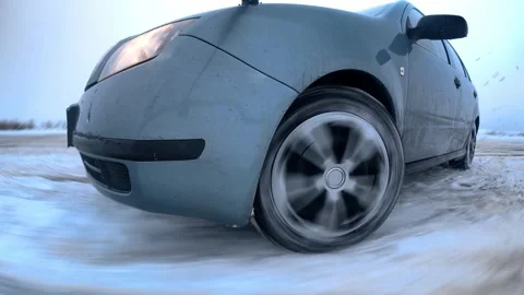 Front view close-up of car drifting on snowy road Stock Footage 327928571