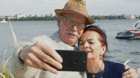Front view close up of Caucasian smiling senior couple taking selfies Stock Footage 116315580