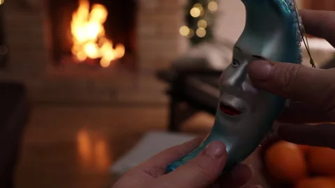 Front view close-up of hands holding a vintage glass Christmas ornament against  Video stock 326072334