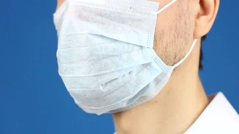 Front view on close-up part of man face, remove used medical mask 動画素材 126998992