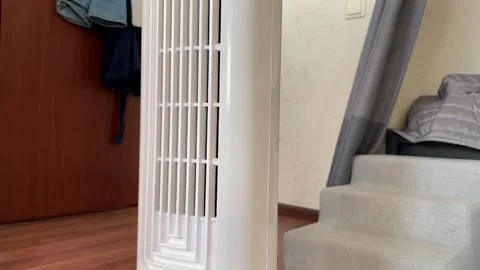 Front view close-up of a white tower fan grille in a bedroom,air circulatio.. Stock Footage 331442599