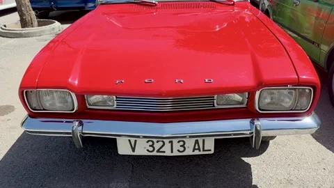 Front view closeup of a classic vintage red Ford Capri coupe car with chrome Stock Footage 337589686