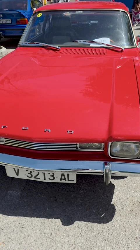 Front view closeup of classic vintage red Ford Capri coupe car with chrome b Stock Footage 337589709