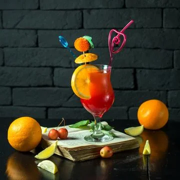 Front view cocktail on an open book with a slice of orange in the form of a.. 写真素材