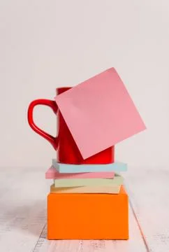 Front view coffee cup blank colored sticky note stacked note pads square box Stock Photos
