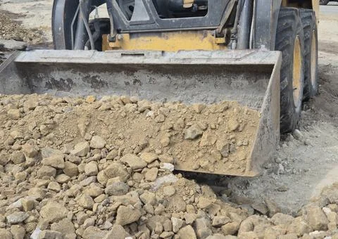 Front View of Compact Wheel Loader Scooping Gravel and Soil Stock Photos