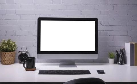 Front view computer, coffee cup, potted plant, books and pencil holder on w.. Stock Photos
