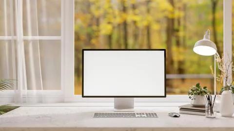 A front view of a computer on a desk, set against a window overlooking a sc.. Illustrazione stock