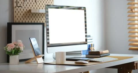 Front view computer with empty display and coffee cup on white table. Stock Photos