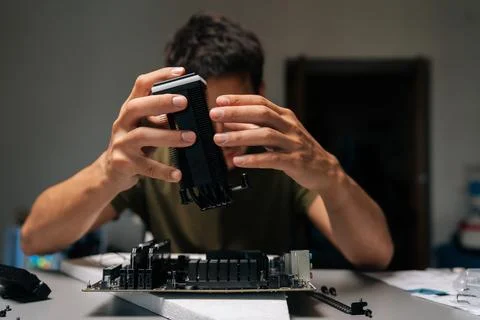 Front view of computer technician installing CPU cooler onto motherboard Stock Photos