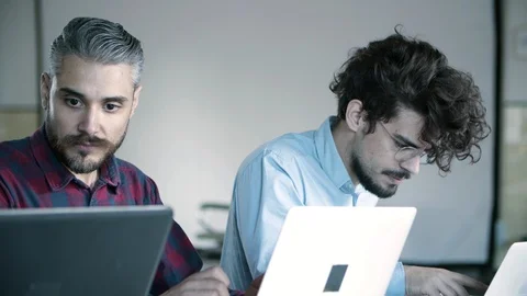 Front view of concentrated developers working with laptops Stock Footage 121401224