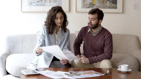 Front view of concentrated home owner looking at blueprint Stock Footage 121003573