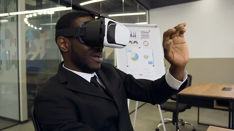 Front view of confident purposeful black-skinned businessman in special virtual Stock Footage 124845497