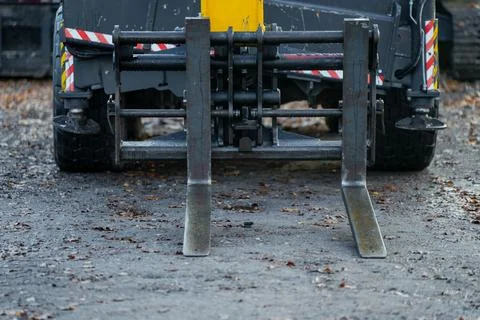 Front view of construction forklift attachment with dual steel pallet forks Stock Photos