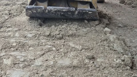Front View of Construction Worker Using Plate Compactor on Soil. Stock Footage 332245920