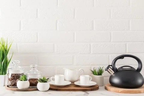 Front view of the countertop of the modern kitchen in white tones with coff.. Stock Photos