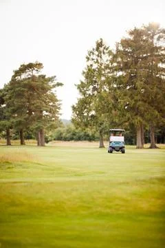 Front View Of Couple Playing Golf Driving Buggy Along Fairway On Red Letter Day Fotos Stock