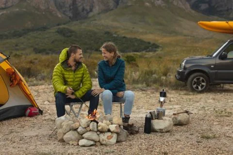 Front view of couple sitting in front of the fire 库存照片