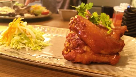 Front view of crispy fried chicken with BBQ barbecue sauce, sliced carrots,.. Video stock 318129288