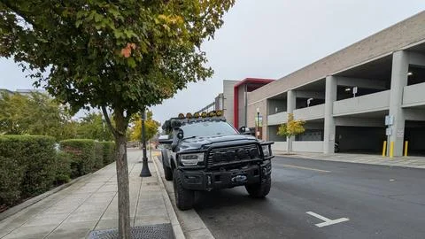 Front view of a customized black Ram off-road truck with oversized tires Photos