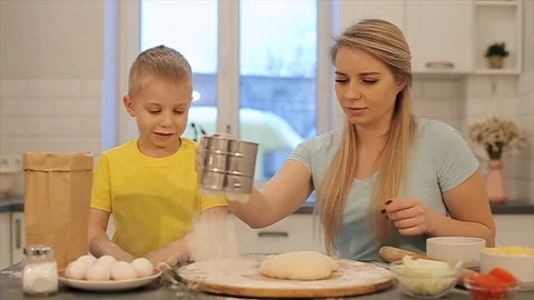 Front view of Cute little boy and his beautiful mom in colorful shirts are Stock-Footage 103314141