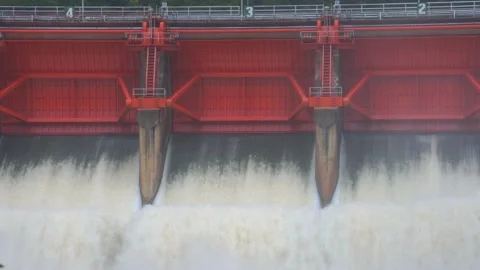 Front view of dam floodgate with massive water discharge and turbulent foam. Stock Footage 315568915