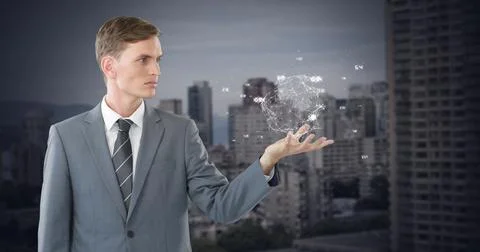 Front view of digital image of a young businessman holding a turning globe in Foto stock