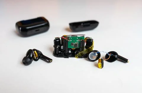 Front View of Disassembled Charging Case Circuitry and Wireless Earbuds Stock Photos