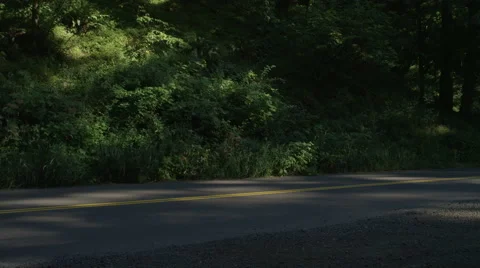 Front view of a Driving Plate: Car turns left from a pullout and travels east on Stock Footage 59300136