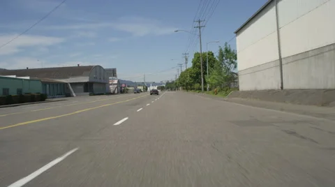 Front view of a Driving Plate: Car travels from the 3300 block on NW Front Stock Footage 59310116