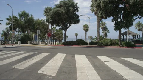 Front view of a Driving Plate: Car traveling on Bicknell Avenue turns onto Ocean Stock Footage 59453297
