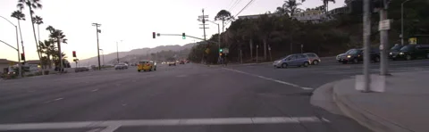 Front view of a Driving Plate: Car travels on Temescal Canyon Road at dusk to Stock Footage 59508127