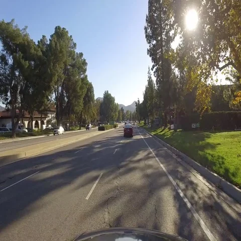 Front view of driving through suburban roads at moderate speed. Camera mounted Stock Footage 69459544