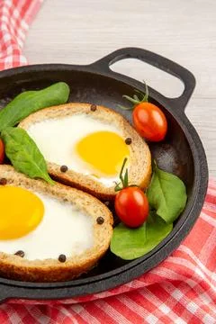 Front view egg toasts inside pan with tomatoes on white background bread co.. Stock Photos