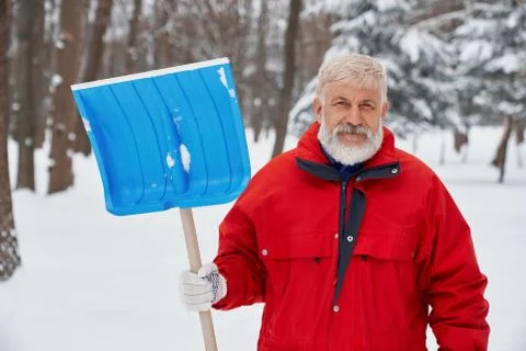 Front view of elder man wearing uniform keeping shovel Stock Photos