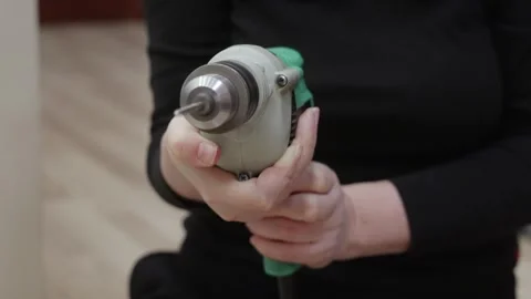 Front view electric drill held by woman indoors Stock Footage 329184619