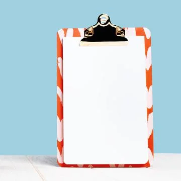 Front view of elegant notepad clipboard mock up on blue Stock Photos