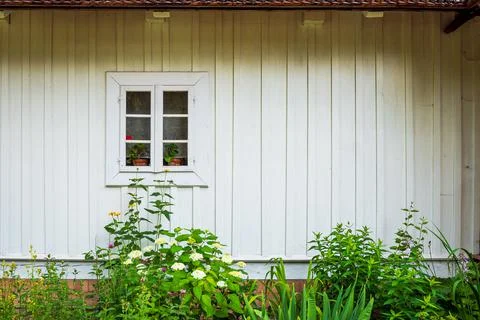 Front view of the facade of the old house. White painted boards. Stock Photos