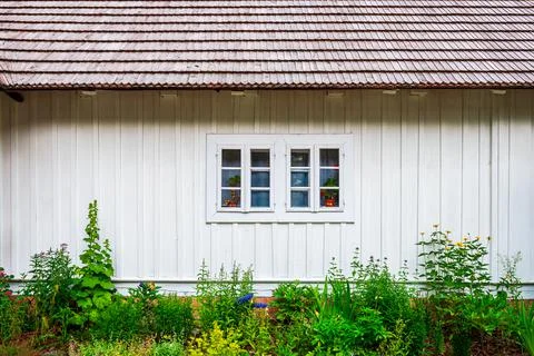 Front view of the facade of the old house. White painted boards and a shingle Stock Photos