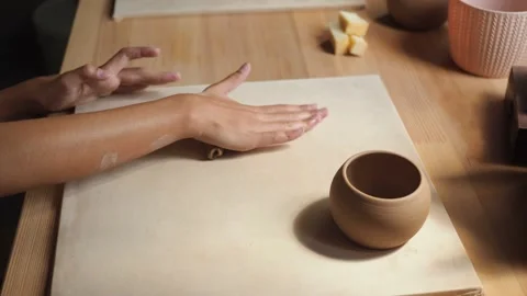 Front view of female potter kneading softly clay on worktop with her hands. Stock Footage 158367937