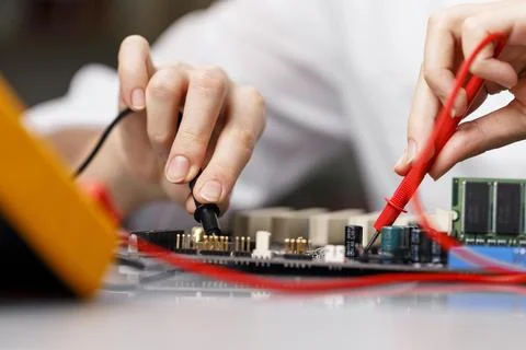 Front view female technician with computer motherboard Stock Photos